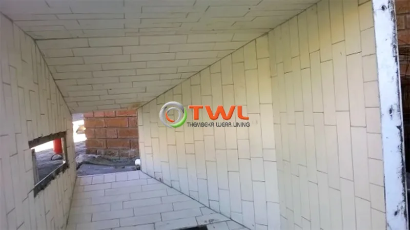 Interior of an industrial chute lined with ceramic tiles