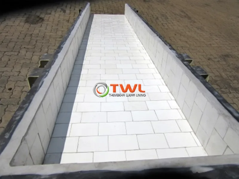 Industrial chute lined with abrasion-resistant ceramic tiles
